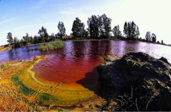 Rio Tinto is a river in Spain that carries the red hue, owing to its high iron levels. It is historically significant for its ancient mining activity, which included copper, gold, and silver. The river's acidic waters have created an environment where only specific organisms thrive, and the region's landscape is often compared to the surface of the moon or Mars.