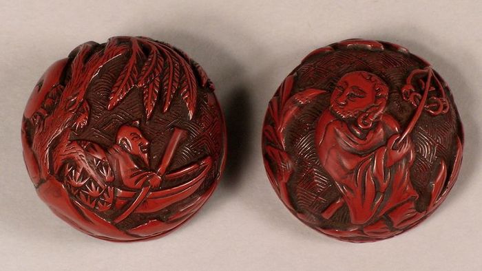 intricately carved red cinnabar lacquer container