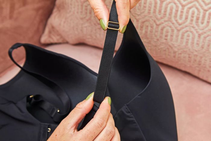 A person adjusts the straps on the Thirdlove All Day Lace Wireless Bra