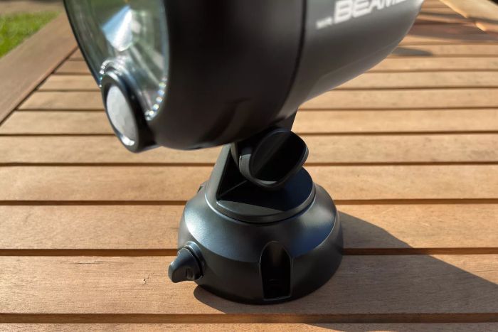 Close-up view of Beams MB360XT 200 Lumen Battery Powered Motion Sensing LED Spotlight placed on a wooden deck