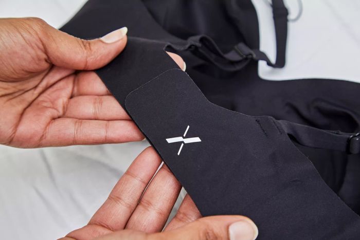 The logo displayed on the strap of the Knix Revolution V-Neck Bra.