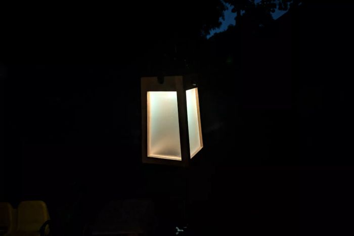 The Pottery Barn Nellie Outdoor Lantern lit up at night
