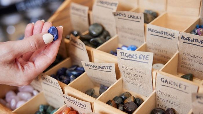 A Woman Selecting Healing Crystals in a Store