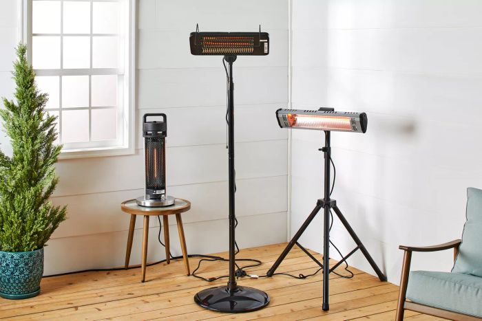 A comparison of three recommended patio heaters, shown in an indoor setting with power on