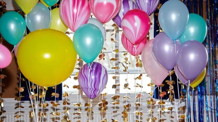 A vibrant assortment of colorful balloons at a birthday party.