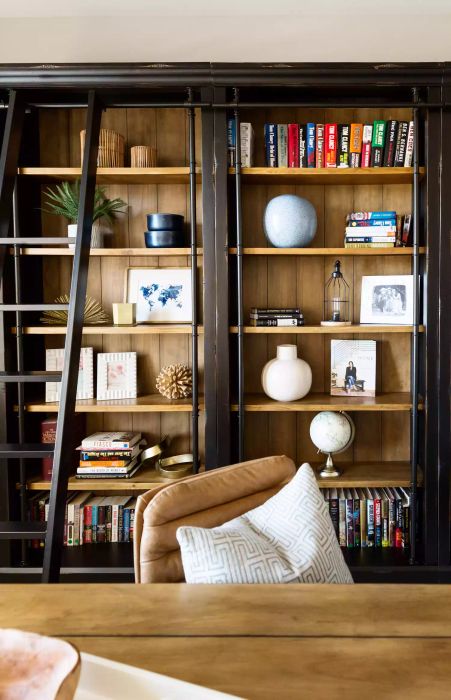 framed family photos on a bookshelf