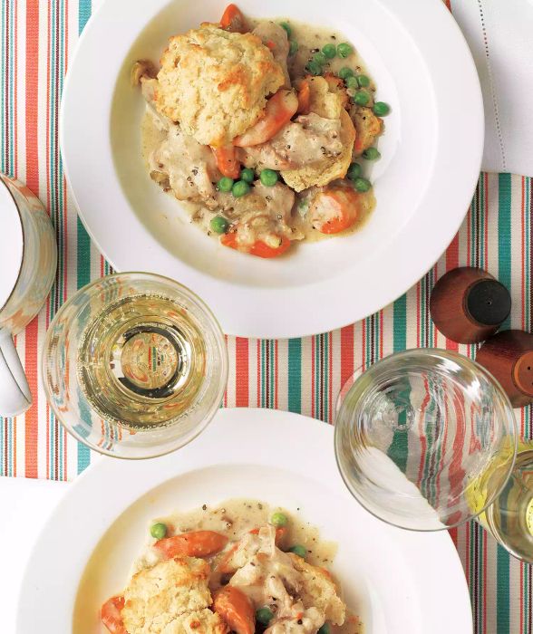 Creamy Slow Cooker Chicken with Biscuits – a hearty and comforting meal that's a breeze to prepare. Just throw carrots, celery, onion, chicken, and a few other key ingredients into the slow cooker. About 30 minutes before the chicken is ready, get started on the biscuits. If time is tight, store-bought biscuits will work just as well for a quick fix.