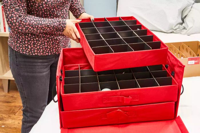 A person takes out the tray from the Santa's Bags 3-Drawer Christmas Ornament Storage Box (holds 72 ornaments)