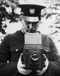 A police officer practices using his new camera in 1935.