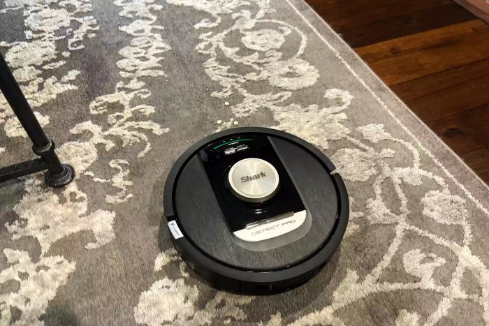The Shark RV2820AE Detect Pro Self-Empty Robot Vacuum in action, cleaning a rug