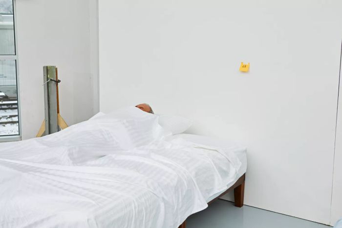 A person lying on a bed dressed with the Chateau Home Collection Egyptian Cotton Sheets