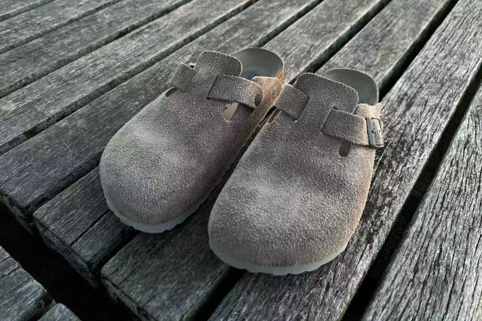 A front view of the Birkenstock Women's Boston Soft Footbed Clog displayed on a deck.