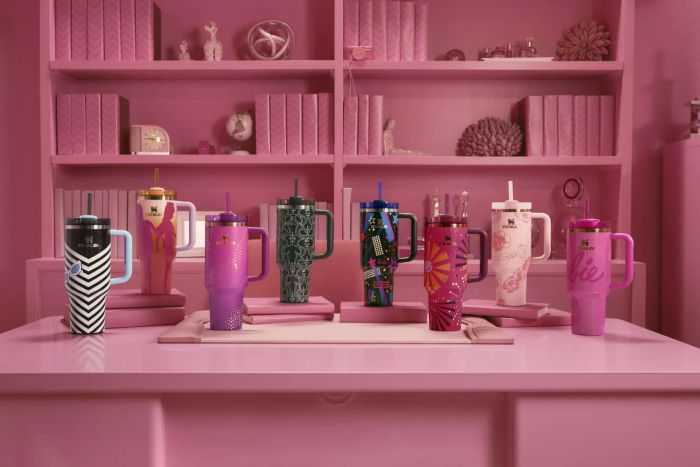 A photo of Stanley’s Limited Edition Barbie Tumblers displayed on a pink table against a pink backdrop