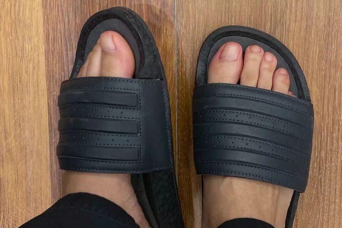 A top-down view of the Adidas Adilette Boost Slides being worn.