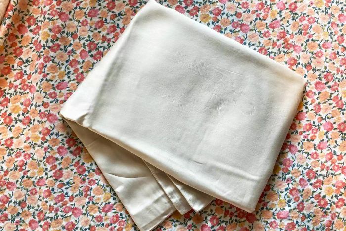 The Cozy Earth Bamboo Pillowcases neatly folded and displayed on a floral-patterned background