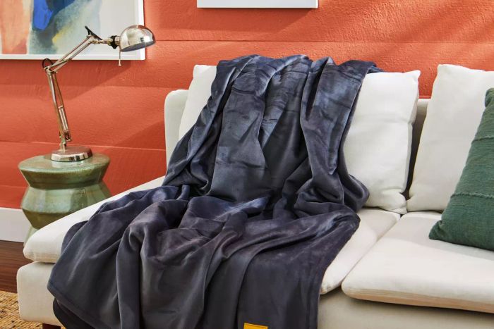 The Big Blanket Co. Original Stretch Blanket placed on a couch
