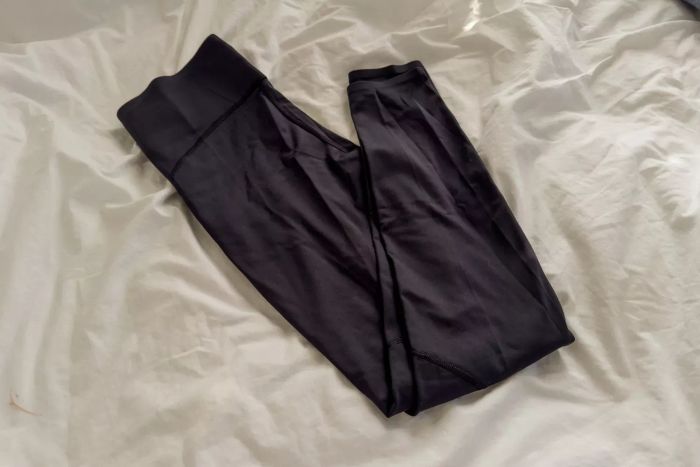 The On Running Movement Tights displayed on a white blanket