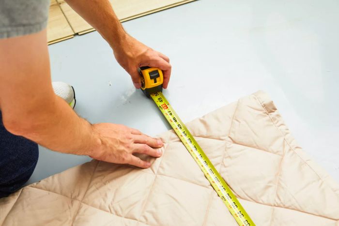 Person taking measurements of the Garnet Hill Plush-Loft Blanket