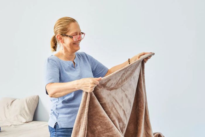 A person admiring the Bare Home Microplush Fleece Blanket