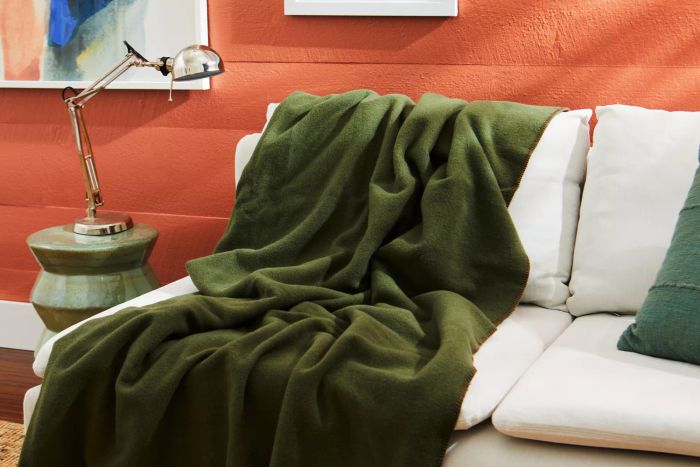 The Faribault Mill Pure & Simple Wool Blanket resting on a couch