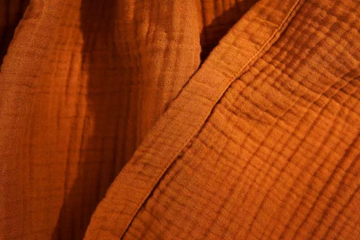 A detailed shot of the hem on the Quince Organic Airy Gauze Blanket
