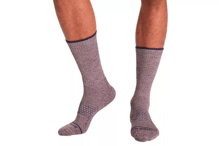 A person wearing the Bombas Men's Merino Wool Adventure Calf Sock 4-Pack.