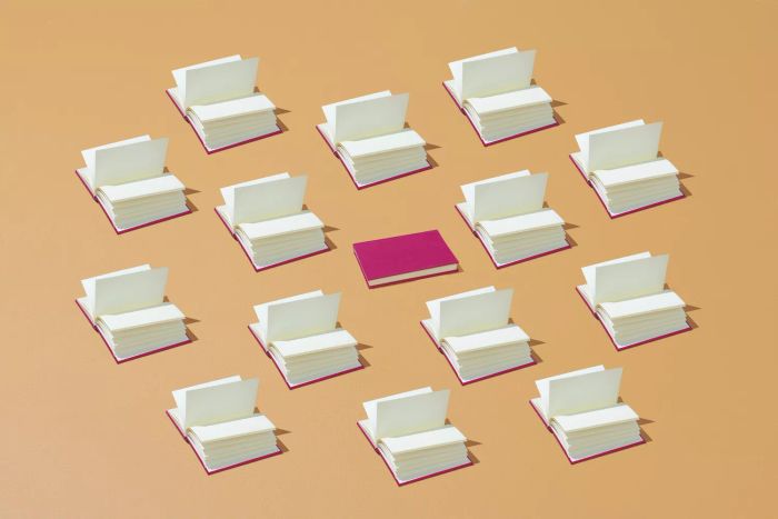 A collection of books arranged in an eye-catching pattern on a vibrant backdrop. One book stands out from the rest