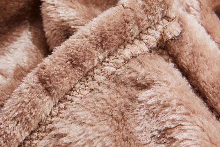 A close-up view of the seam on the Bare Home Microplush Fleece Blanket