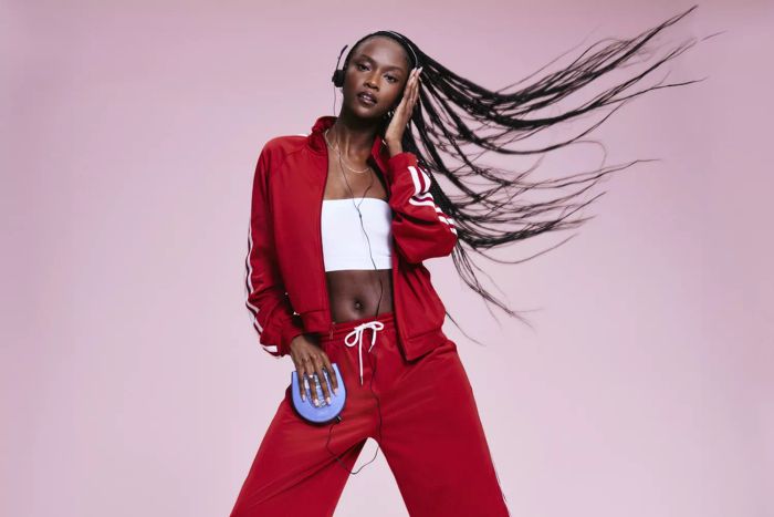 A woman in pink showcasing Old Navy’s 1990s-inspired collection