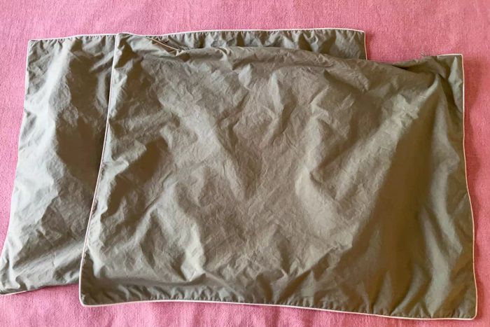 Brooklinen Classic Percale Pillowcases showcased on a soft pink background