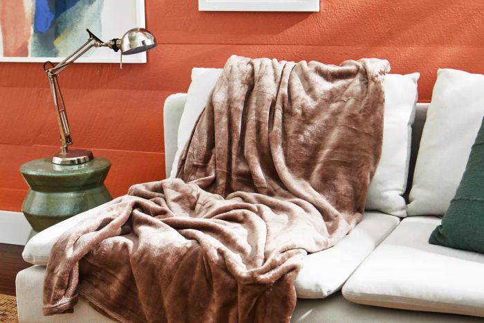 The Bare Home Microplush Fleece Blanket spread across a couch
