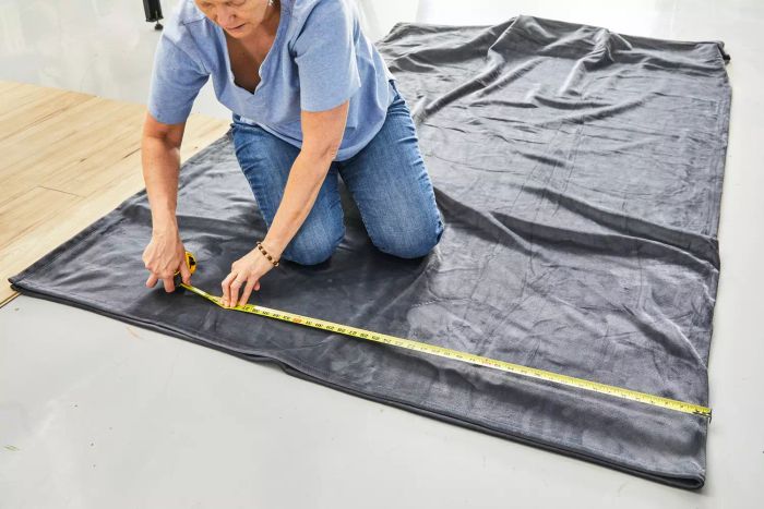 Someone measuring the Big Blanket Co. Original Stretch Blanket