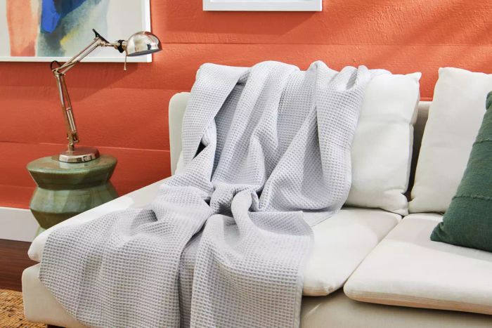 The Boll & Branch Waffle Bed Blanket draped elegantly across a couch