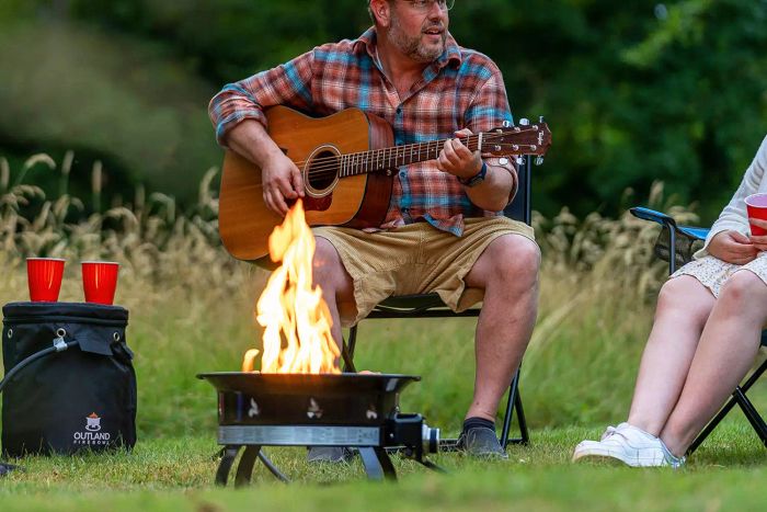 A person playing guitar by an Outland Living 19