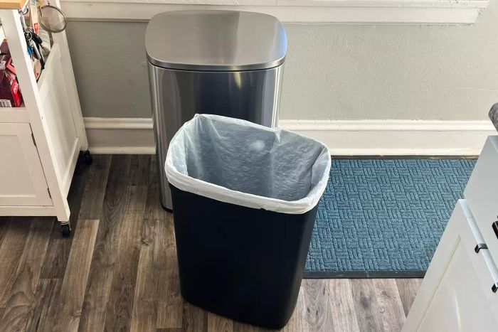 The removable inner bin placed in front of the FDW 13 Gallon Kitchen Step Trash Can