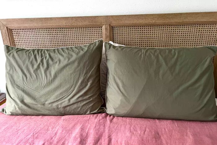 Two Brooklinen Classic Percale Pillowcases displayed upright with pillows neatly tucked inside