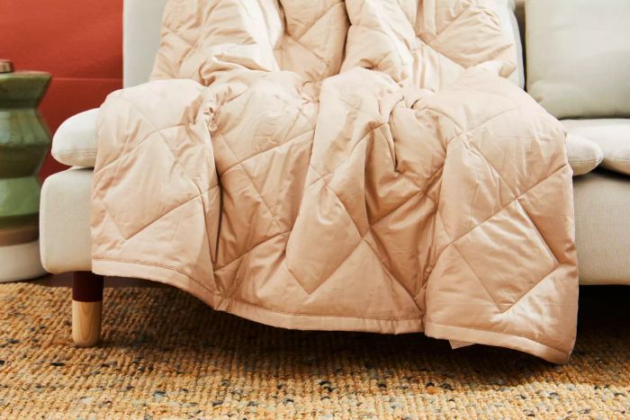 The Garnet Hill Plush-Loft Blanket laid across a couch