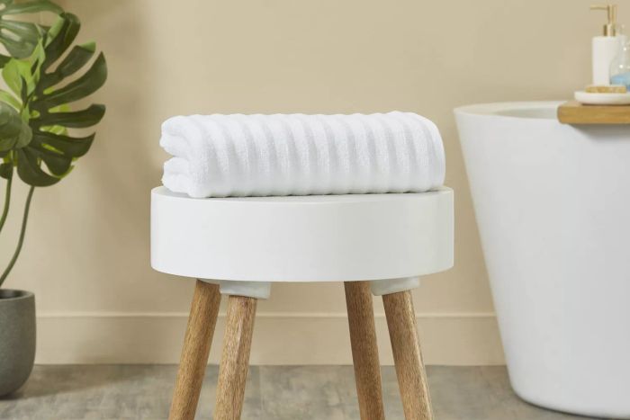 Mainstays Performance Textured Bath Towel displayed on a bathroom bench