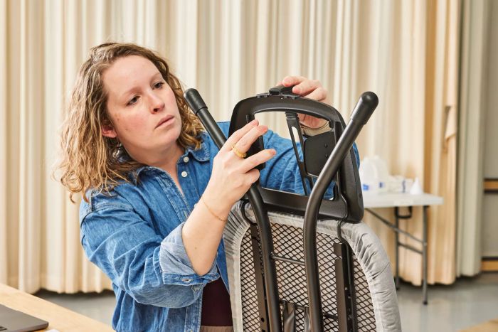 A person assembling the Bartnelli Heavy Duty Ironing Board.