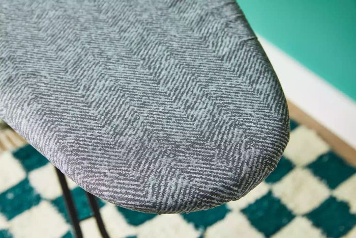 A close-up view of the edge of the Bartnelli Heavy Duty Ironing Board.