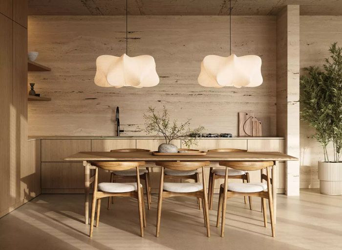 A beautifully designed kitchen dining area showcasing distinctive pendant lights and a modern wooden dining set in a stylish interior