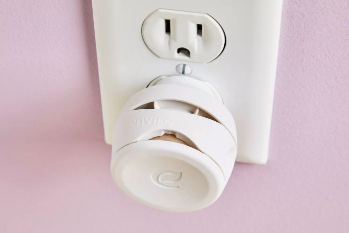 a detailed view of the Enviroscent Plug Hub Starter Kit connected to a wall outlet