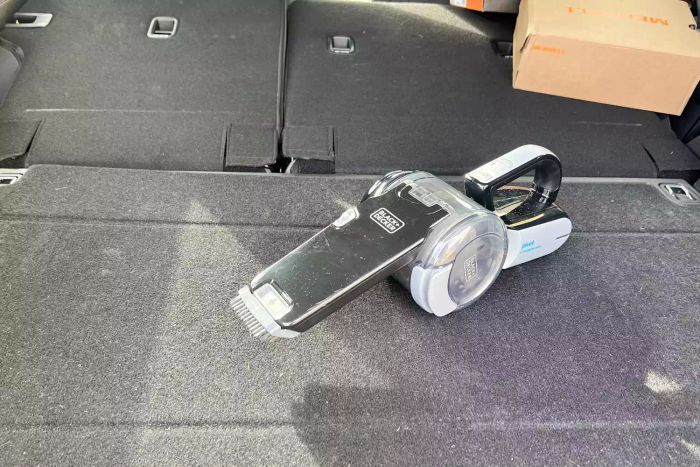 The BLACK+DECKER 20V Max Handheld Vacuum, Cordless, Grey (BDH2000PL) after cleaning a car interior