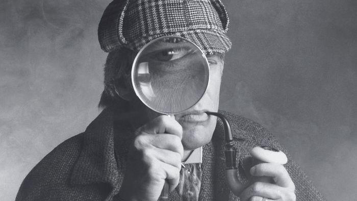 A monochrome image depicting a detective wearing a plaid cap, holding a pipe, and peering through a spyglass
