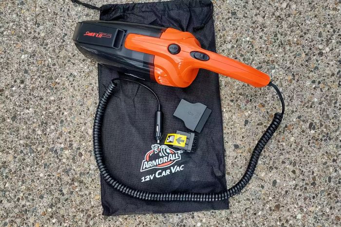 The ArmorAll Armor All-12V Wet/Dry Car Vac (AA12V10901) shown with its storage bag and accessories