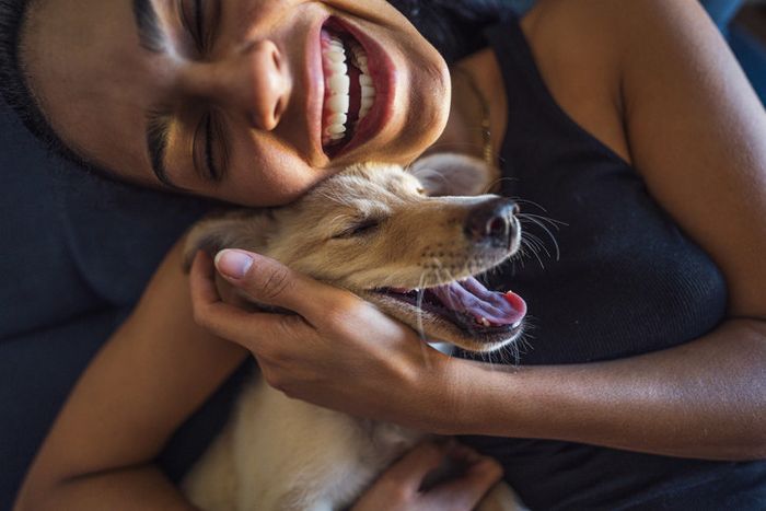 A woman embracing her pet dog