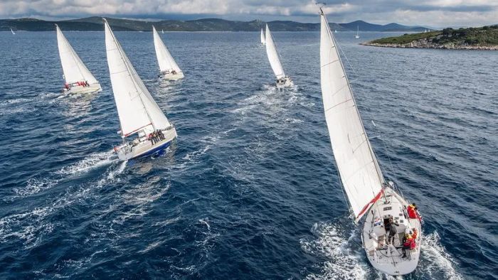 massive sailboats competing in a race