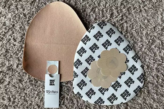 The Brassybra Adhesive Bra, featuring nipple covers and other accessories.