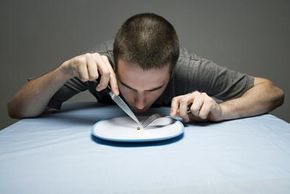 A person staring at a nearly empty plate