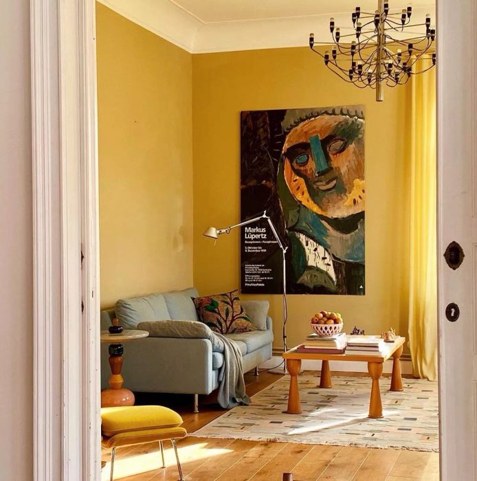 A living room adorned in a soft, muted yellow paint.